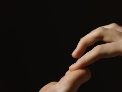 Close-up of hands in a meditative gesture.