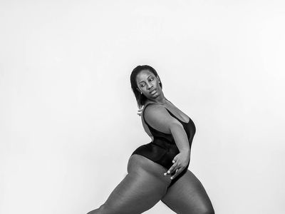 Person in a graceful flowing movement pose in a studio.